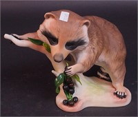A Cybis figurine of a Raffles the Raccoon,