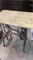 Marble top table with iron sewing machine base