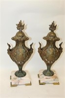 Pair of Metal Lidded Urns on marble bases,