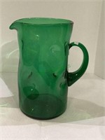 Emboli dimpled pitcher measures 10 inches tall.