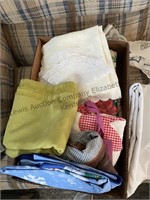 Box of plastic tablecloths, cloth table linens