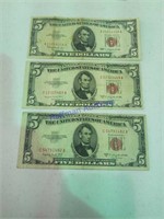 3 - 5 dollar bills with red seal.  2 1953 series