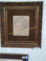 Child face in ornate frame
