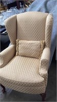 Gold colored wing back chair