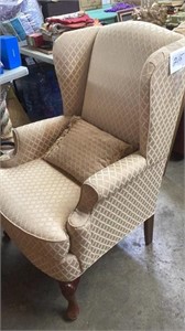 Gold colored wing back chair