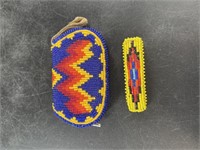 An intricately beaded coin purse with barrette in