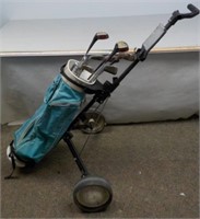 Golf bag clubs and hand cart and accessories.