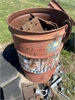 Metal burn barrel full of steel plates.