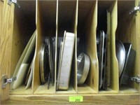 All baking pans in upper cabinet