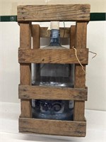Plastic water jug in wooden crate used as wine