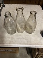 Three glass milk bottles
