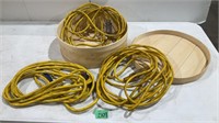 3 yellow extension cords in wood box