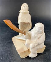 Ivory carving of a successful hunt with two figure
