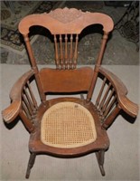 Antique carved walnut rocking chair w/ cane seat