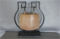 wooden bell in wraught iron frame