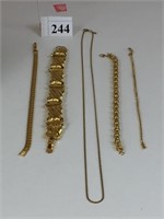 FOUR MONET GOLD TONE BRACELETS AND ONE CHAIN