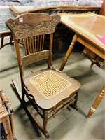 Vintage wooden rocking chair with woven seat