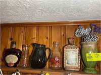 Top shelf over coffee maker, assorted vases, milk