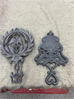 2 cast iron trivets