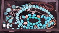 Container of necklaces and bracelets, some