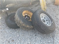 Three heavy duty tires wheels, one for skid steer