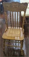 Wood and wicker chair w/ engraved face pattern