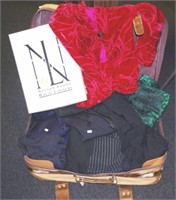 A suitcase of various designer ladies clothes