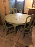 Green wood table with three chairs