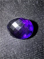 One very large round cut, faceted deep purple