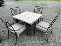 Outdoor tile top table with four chairs and