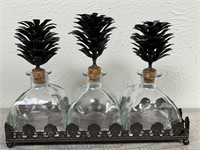 Fancy metal tray with jars and pinecone stoppers