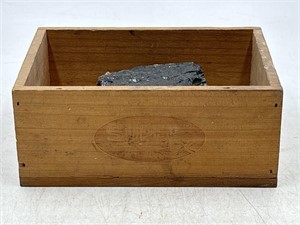 Wooden box with a piece of coal