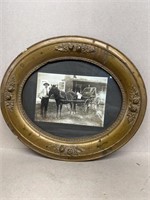 Early frame photo with man by horse and buggy