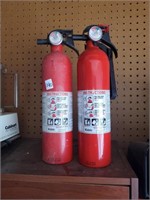 Two Empty Fire Extinguishers