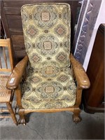 Cushioned wooden recliner.