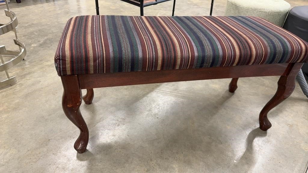 Cushioned Bench with Striped Fabric Upholstery.