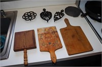 3 Cast iron trivets and 3 wooden cutting boards