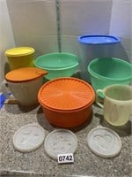 Tupperware pieces and one plastic canister