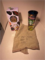 starbucks cup, tea towel and liquor tin