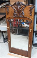 Ornate mirror with coat hooks