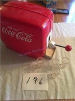 Vintage Coke machine with four glasses
