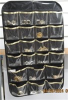 LOT OF COSTUME JEWELRY IN HANGING DISPLAY BAG.