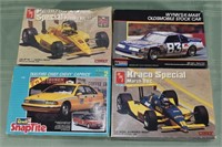 Four 1:25 scale die cast plastic car models; as is