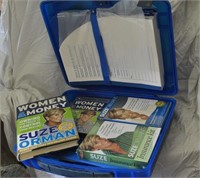 Suze Orman books in plastic briefcase