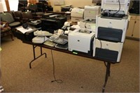 Table with 7 Laser Printers, 10 Calculators,