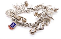 Silver charm bracelet with heart locket clasp