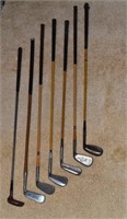 7 vintage golf clubs, some with wood handles; as i