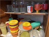 Cabinet full of glasses and plastic storage