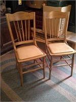 two wood chairs with padding