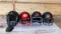 Three baseball helmets and one catcher helmet